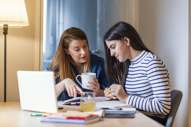 Mum helps her daughter with homework