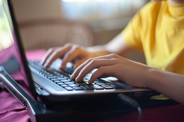 Young boy using laptop.